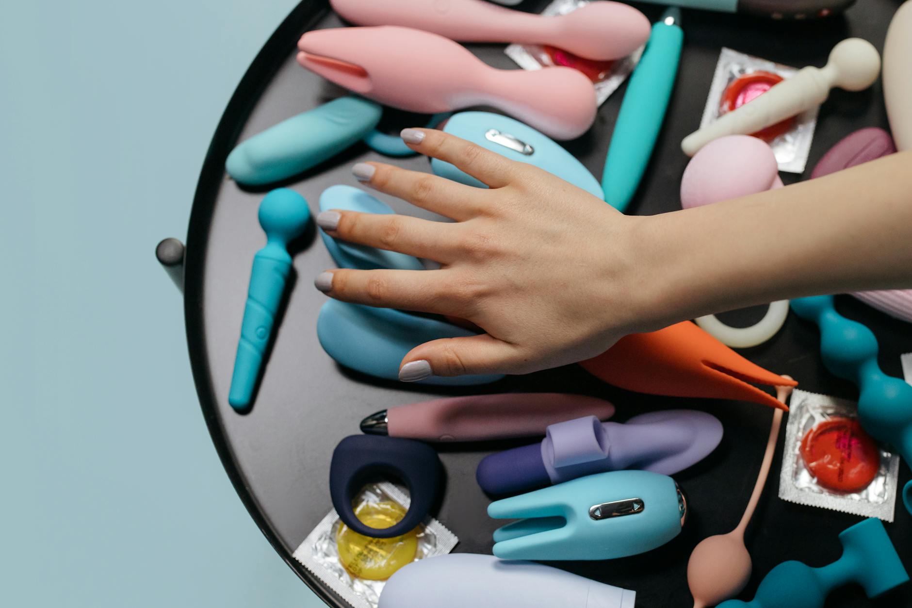 Colorful arrangement of vibrators on a bright yellow background showcasing various shapes and intensities